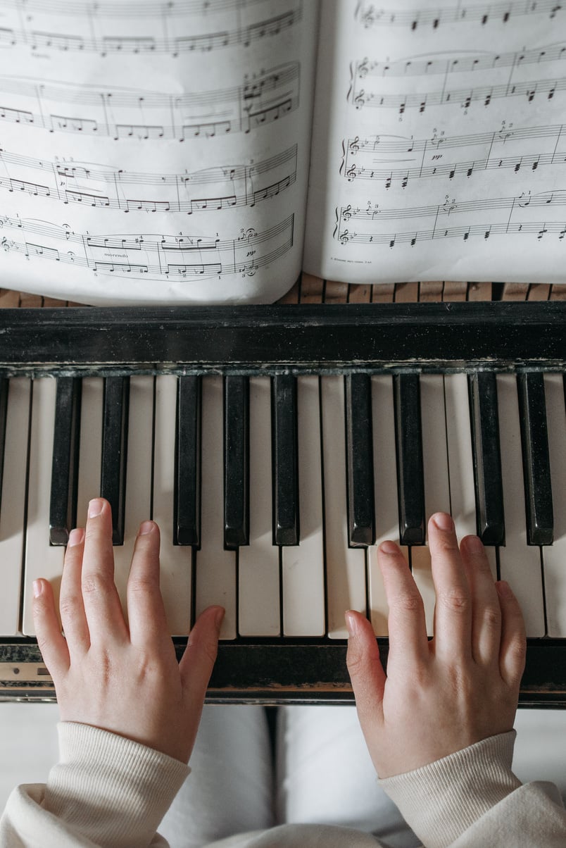 Person Playing Piano With Musical Notes